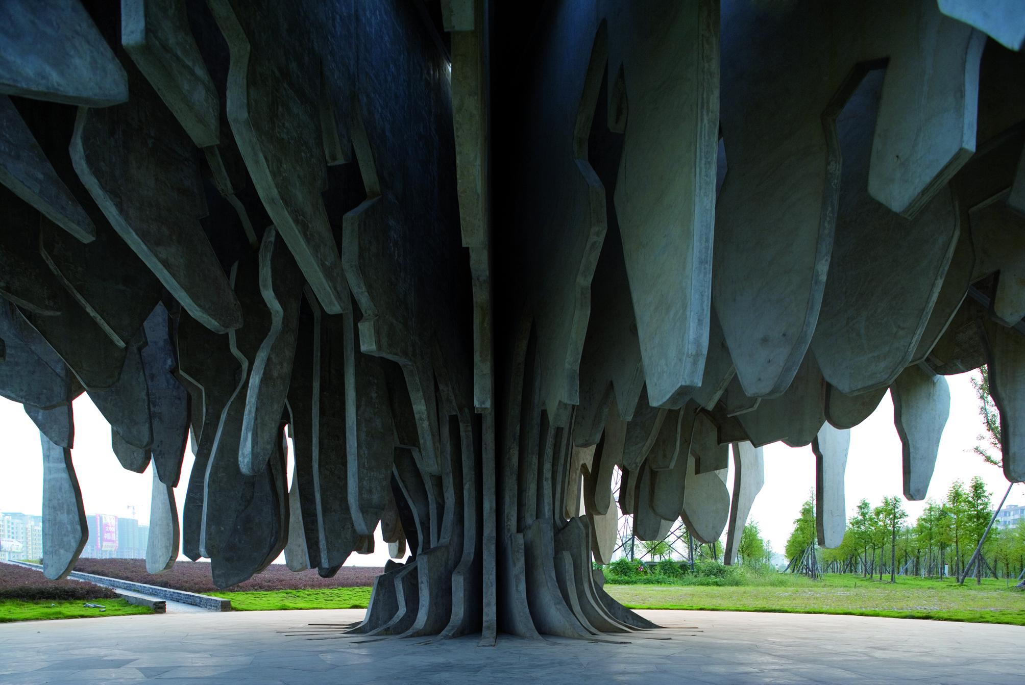 The concrete branches of the tree shelter and enclose a tranquil space