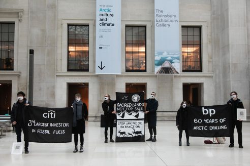 Protesters at the British Museum hold signs that say 'BP: 60 years of arctic drilling' and 'citi: 3rd largest investor in fossil fuels'