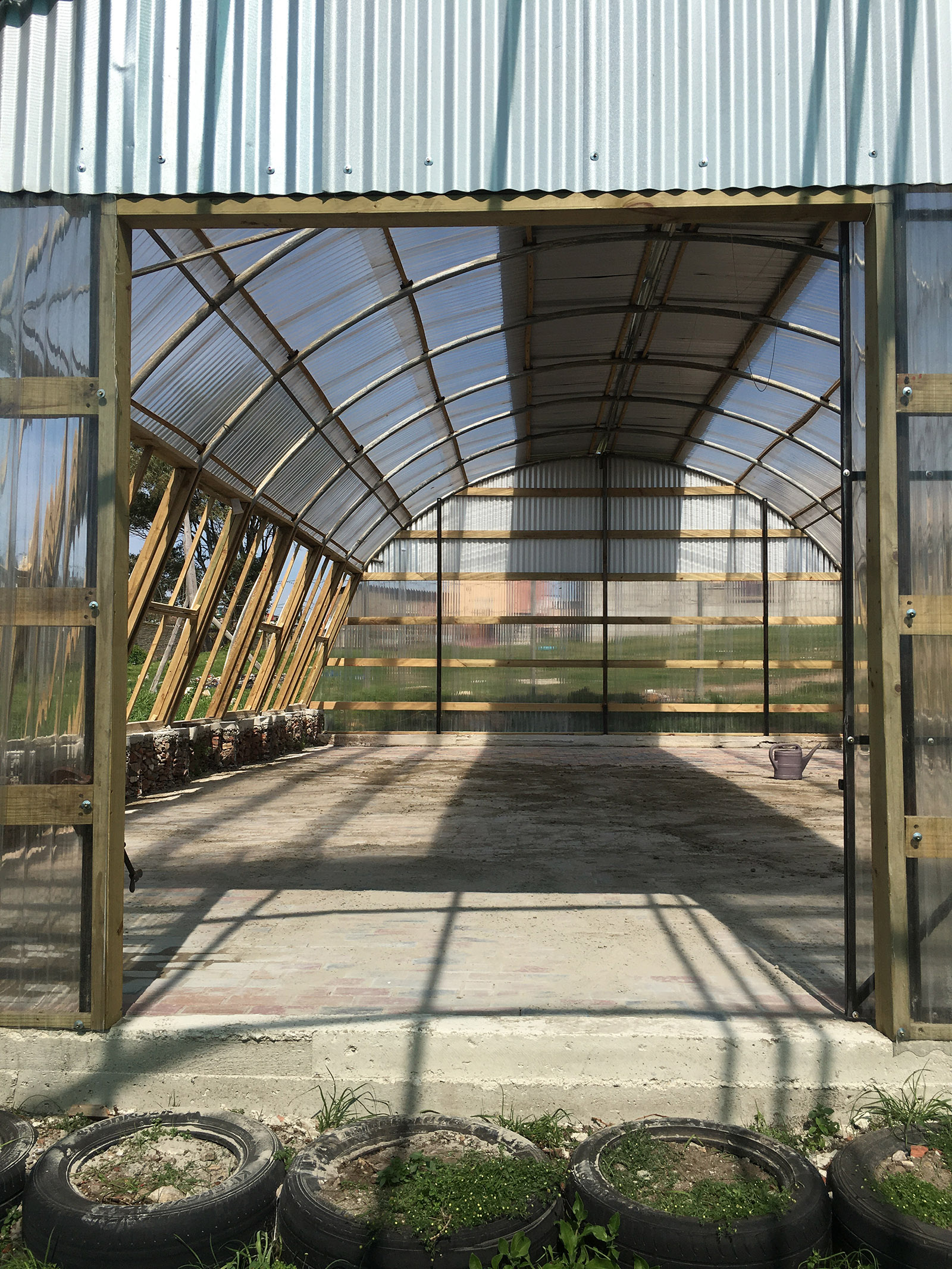 The training hall of the Lim'uphile Co-op by Collectif Saga is made from recycled tubular steel arches
