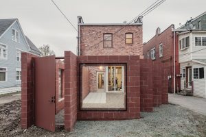 The back of the restaurant has been extended into a terrace with zig-zagging walls in red blockwork and a large window at the end