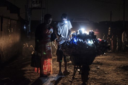 a light vendor in the Bariga neighbourhood of Lagos sells hand-held battery powered light