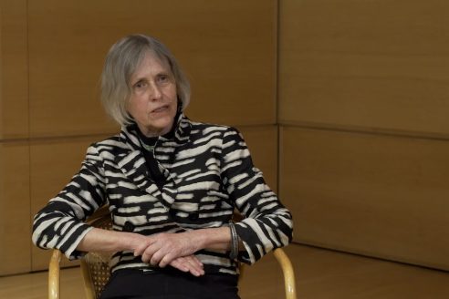 Iwona Buczkowska sits for an interview in a timber-paneled room