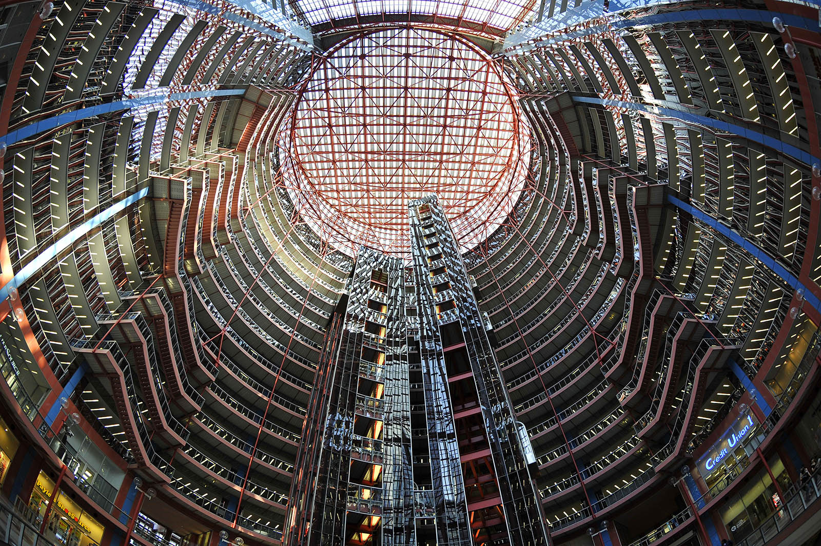 The Chicago Loop's James R Thompson Centre by Helmut Jahn Architect. The photograph looks up through its atrium to a translucent ceiling and red steel lattice