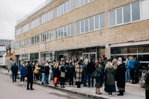 People congregating outside the entrance of Thoravej 29 in Copenhagen, Denmark