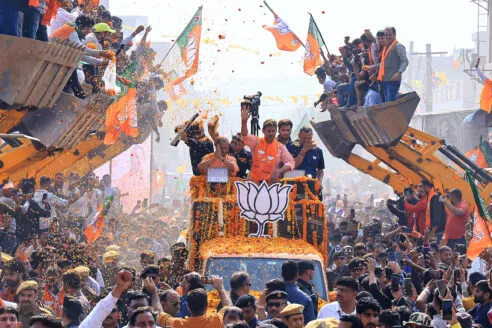 Uttar Pradesh Chief Minister Yogi Adityanath is participating in a roadshow aboard a bulldozer in support of BJP candidate Rajyavardhan Singh Rathore from the Jhotwara constituency ahead of the Rajasthan Assembly elections in Jaipur, Rajasthan, India,