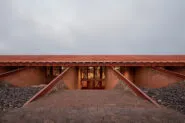 A broad stair descends to the entrance between banks of excavated stone, and leads to two storeys of offices of the tequila factory