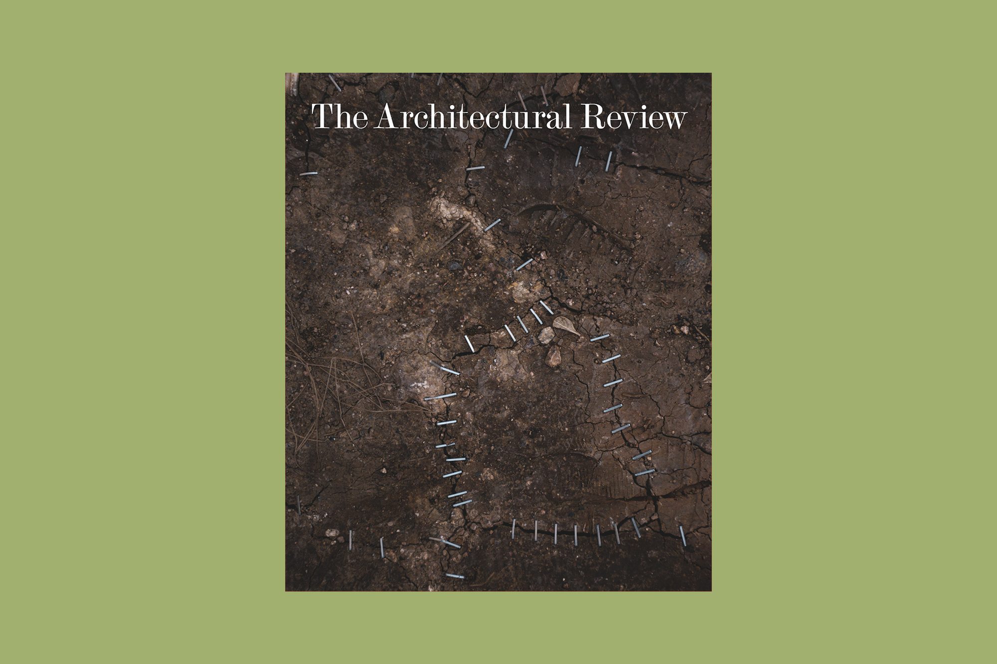 the cover of The Architectural Review February 2024 issue with theme 'repair'. The cover shows cracks in brown earthy ground stapled over to represent repair, and is featured over a green background