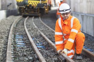 Crossrail track being laid by construction worker