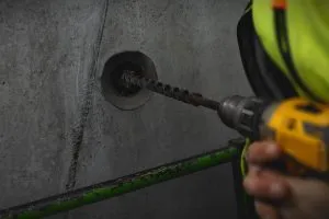 workman-drilling-hole-in-wall_shutterstock_2106254804-300x200.webp